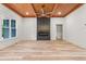 Open-concept living room features stylish fireplace, wood ceiling, and abundant natural light from a large window at 260 Ellington Rd, Graham, NC 27253