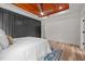Bright main bedroom with paneled wall and wood-look floors at 260 Ellington Rd, Graham, NC 27253