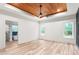 Spacious main bedroom with wood ceiling, fan, two windows, and ensuite bathroom at 260 Ellington Rd, Graham, NC 27253