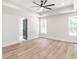 Spacious main bedroom with a tray ceiling, ceiling fan, and ample natural light at 260 Ellington Rd, Graham, NC 27253