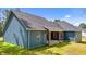 Rear exterior showcasing the home's blue siding, covered porch, and new roof, perfect for outdoor living and curb appeal at 260 Ellington Rd, Graham, NC 27253