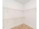 A walk-in closet featuring white wire shelving along the walls and wood-look flooring at 260 Ellington Rd, Graham, NC 27253
