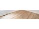 Wood-look flooring with white baseboards and a vent, complemented by a wall outlet at 260 Ellington Rd, Graham, NC 27253