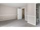 Spacious bedroom with carpet flooring and access to upper level at 3 Patriot Cir, Durham, NC 27704