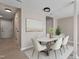 Bright dining room with modern furniture, light wood floors, and neutral colors at 3 Patriot Cir, Durham, NC 27704