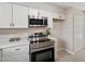 Modern kitchen with stainless steel appliances and white cabinets at 3 Patriot Cir, Durham, NC 27704
