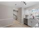 Bright kitchen with white cabinets, stainless steel appliances, and light wood floors at 3 Patriot Cir, Durham, NC 27704