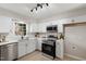 Modern kitchen featuring stainless steel appliances, white cabinets, and quartz countertops at 3 Patriot Cir, Durham, NC 27704
