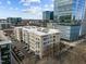 An aerial shot showcasing a city apartment building with surrounding structures and parking at 317 W Morgan Street # 405, Raleigh, NC 27601