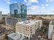 Aerial view of a modern apartment building in a city setting with ample parking at 317 W Morgan Street # 405, Raleigh, NC 27601