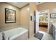 Inviting bathroom featuring a soaking tub and an open doorway to the main bedroom at 317 W Morgan Street # 405, Raleigh, NC 27601
