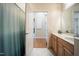 Bathroom with a marble countertop sink, wood cabinets, and a shower curtained shower at 317 W Morgan Street # 405, Raleigh, NC 27601