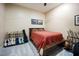 Spacious bedroom with room for guitars on display, a ceiling fan, and a large bed at 317 W Morgan Street # 405, Raleigh, NC 27601