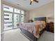 Bedroom with private balcony and dark wood platform bed at 317 W Morgan Street # 405, Raleigh, NC 27601