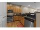 Modern kitchen with wood cabinets, granite countertops, and stainless steel appliances at 317 W Morgan Street # 405, Raleigh, NC 27601