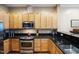 Well-maintained kitchen featuring stainless steel appliances, ample wood cabinetry, and dark countertops for a modern feel at 317 W Morgan Street # 405, Raleigh, NC 27601