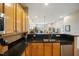 Open concept kitchen with granite counters and stainless steel appliances overlooks the living area at 317 W Morgan Street # 405, Raleigh, NC 27601