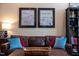 Inviting living room features a brown leather couch with colorful pillows and framed art at 317 W Morgan Street # 405, Raleigh, NC 27601