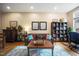 Inviting living area with leather seating, hardwood floors, and a cozy workspace for relaxation or productivity at 317 W Morgan Street # 405, Raleigh, NC 27601