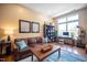 Comfortable living room with hardwood floors, a leather sofa, and a dedicated workspace with a scenic window view at 317 W Morgan Street # 405, Raleigh, NC 27601
