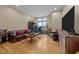 Living room with a leather couch, coffee table, and large TV at 317 W Morgan Street # 405, Raleigh, NC 27601