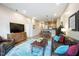 Inviting living area with hardwood floors, a leather sofa, and a view into the dining area and kitchen at 317 W Morgan Street # 405, Raleigh, NC 27601