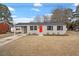 Charming single-story home with a red front door, large windows, and well-maintained lawn at 322 Pace St, Smithfield, NC 27577