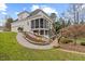 Back exterior view showing a screened porch, decks, mature trees and landscaped yard at 3225 Mossy Ridge Ct, Raleigh, NC 27613