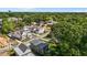 Stunning aerial view of modern homes in a lush, green neighborhood with mature trees and blue skies at 324 Waldo St, Cary, NC 27511