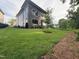 Well-manicured backyard featuring a lush lawn and mature tree, complementing the modern home's design at 324 Waldo St, Cary, NC 27511