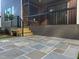 Backyard patio with blue slate, a wood staircase, gray brick foundation, and dark screened porch at 324 Waldo St, Cary, NC 27511