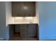 Home bar area with granite countertop, tile backsplash, cabinets and drawers at 324 Waldo St, Cary, NC 27511