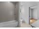 Modern bathroom featuring a tub, shower, tiled walls, and bright window at 324 Waldo St, Cary, NC 27511
