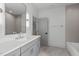 Modern bathroom features double vanity, a bathtub, and sleek gray tones throughout at 324 Waldo St, Cary, NC 27511