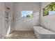 Bright bathroom with a modern soaking tub, walk-in shower, and elegant marble tiling at 324 Waldo St, Cary, NC 27511