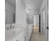 Bright bathroom featuring a long vanity with double sinks and modern fixtures at 324 Waldo St, Cary, NC 27511