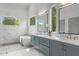 Elegant bathroom featuring double vanity with quartz counters, modern fixtures, and a luxurious soaking tub at 324 Waldo St, Cary, NC 27511