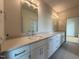 Bathroom featuring dual sinks, white cabinets, quartz countertops, and tile floors at 324 Waldo St, Cary, NC 27511
