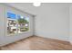 Bright bedroom with hardwood floors and a large window offering views of the neighborhood at 324 Waldo St, Cary, NC 27511
