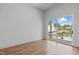 Spacious bedroom with hardwood floors and sliding glass doors leading to a balcony at 324 Waldo St, Cary, NC 27511