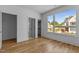 Bedroom with hardwood floors and large window, showcasing the house under construction at 324 Waldo St, Cary, NC 27511
