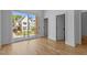 Bedroom with hardwood floors and sliding glass doors leading to a balcony with neighborhood views at 324 Waldo St, Cary, NC 27511