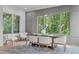 Dining room with large windows providing a view of the surrounding trees, modern chandelier, and wood floors at 324 Waldo St, Cary, NC 27511