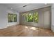 Bright dining room with hardwood floors, decorative trim, and large windows overlooking the greenery at 324 Waldo St, Cary, NC 27511