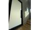 Modern entryway featuring a sleek, large door, leading to the hardwood staircase and bright interiors at 324 Waldo St, Cary, NC 27511