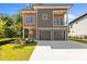 Modern two-story home with a two-car garage, balcony, and wood and gray siding at 324 Waldo St, Cary, NC 27511