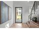 Bright foyer with hardwood floors, modern art, and a view to the front yard at 324 Waldo St, Cary, NC 27511