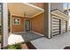 Inviting front porch with wood paneling, stone tile, and a modern glass door at 324 Waldo St, Cary, NC 27511