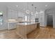 Modern kitchen featuring a large island, pendant lighting, stainless steel appliances, and custom cabinetry at 324 Waldo St, Cary, NC 27511