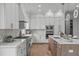 Well-appointed kitchen with updated appliances and an island with a sink and seating at 324 Waldo St, Cary, NC 27511